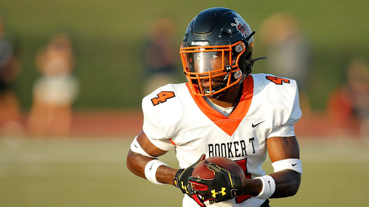 Tulsa Booker T. Washington's Micah Tease runs after a catch against Southmoore on Aug. 26, 2021.

jump