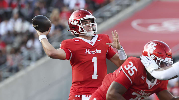 Nov 22, 2025; Houston, Texas, USA; Houston Cougars quarterback Conner Weigman (1) throws a pass for a touchdown during the second quarter against the TCU Horned Frogs at TDECU Stadium. Mandatory Credit: Troy Taormina-Imagn Images