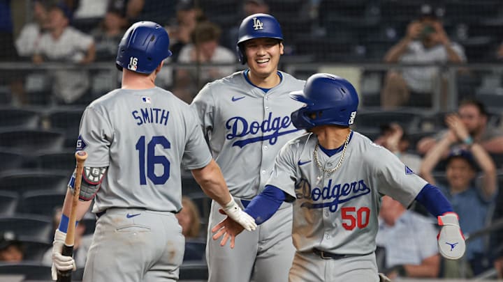 Jun 8, 2024; Bronx, New York, USA; Los Angeles Dodgers designated hitter Shohei Ohtani (17) and catcher Will Smith (16) and shortstop Mookie Betts (50) celebrate during the ninth inning against the New York Yankees at Yankee Stadium. Mandatory Credit: Vincent Carchietta-Imagn Images