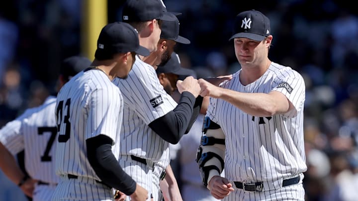 Mar 27, 2025; Bronx, New York, USA; New York Yankees injured starting pitcher Gerrit Cole (45) fist bumps teammates during introductions before an opening day game against the Milwaukee Brewers at Yankee Stadium. Mandatory Credit: Brad Penner-Imagn Images