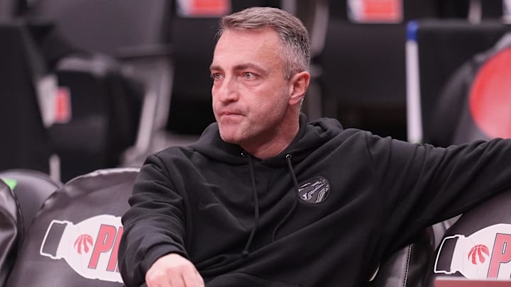 Toronto Raptors head coach Darko Rajakovic watches warm up before a game against the Charlotte Hornets. Toronto Raptors head coach Darko Rajakovic watches warm up before a game against the Charlotte Hornets.