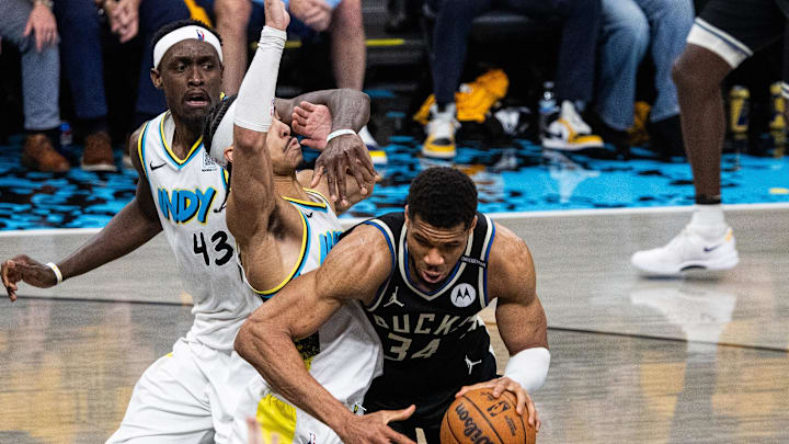 Apr 29, 2025; Indianapolis, Indiana, USA; Milwaukee Bucks forward Giannis Antetokounmpo (34) dribbles the ball while Indiana Pacers guard Andrew Nembhard (2) defends during game five of the first round for the 2024 NBA Playoffs at Gainbridge Fieldhouse. Mandatory Credit: Trevor Ruszkowski-Imagn Images Apr 29, 2025; Indianapolis, Indiana, USA; Milwaukee Bucks forward Giannis Antetokounmpo (34) dribbles the ball while Indiana Pacers guard Andrew Nembhard (2) defends during game five of the first round for the 2024 NBA Playoffs at Gainbridge Fieldhouse. Mandatory Credit: Trevor Ruszkowski-Imagn Images