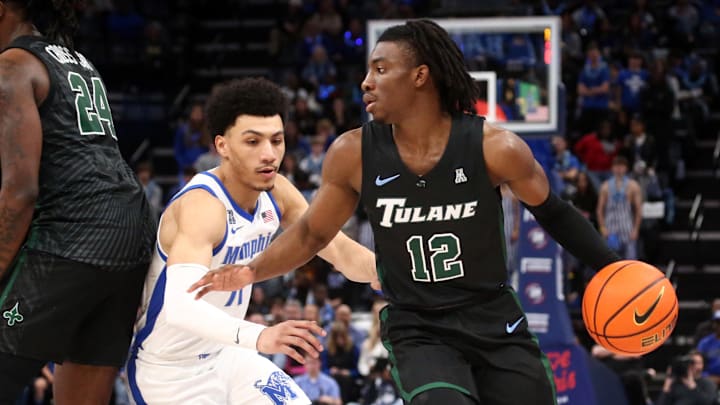 Feb 11, 2024; Memphis, Tennessee, USA; Tulane Green Wave guard Kolby King (12) dribbles as Memphis Tigers guard Jahvon Quinerly (11) defends during the second half at FedExForum. Mandatory Credit: Petre Thomas-Imagn Images