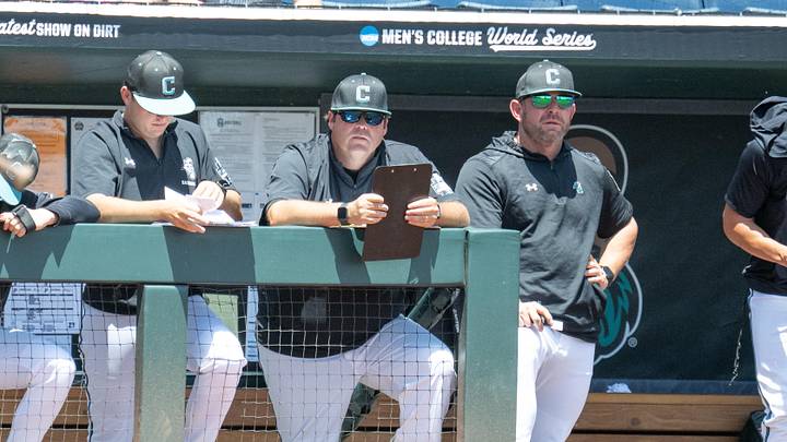 Jun 22, 2025; Omaha, Neb, USA;  Coastal Carolina Chanticleers head coach Kevin Schnall (9) (right) watches action against the LSU Tigers during the first inning at Charles Schwab Field. Mandatory Credit: Steven Branscombe-Imagn Images