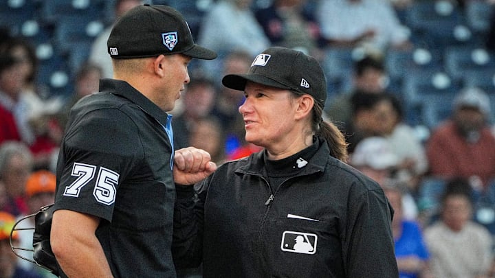 Umpires Jen Powal and Tom Woodring (75) discuss before a spring training game between the Houston Astros and Washington Nationals on Saturday, February 24, 2024 at the Cacti Stadium in West Palm Beach.