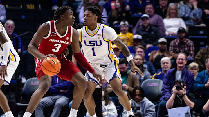 Jan 14, 2025; Baton Rouge, Louisiana, USA;  Arkansas Razorbacks forward Adou Thiero (3) dribbles against LSU Tigers guard Jordan Sears (1) during the first half at Pete Maravich Assembly Center. Mandatory Credit: Stephen Lew-Imagn Images