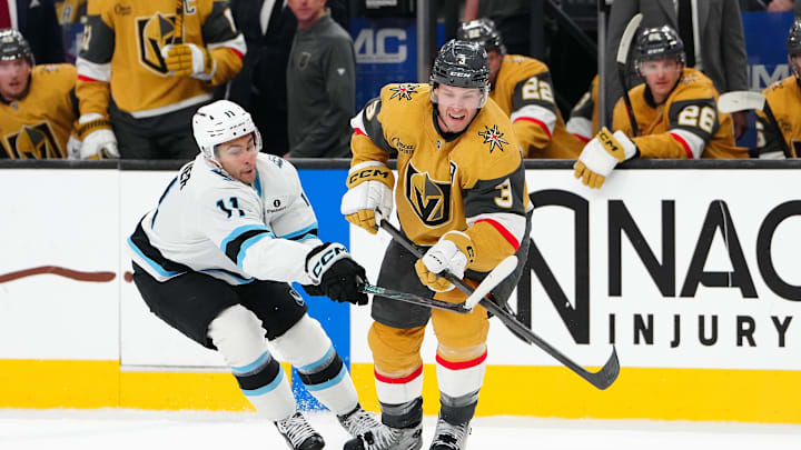 Mar 19, 2026; Las Vegas, Nevada, USA; Utah Mammoth right wing Dylan Guenther (11) slashes the stick of Vegas Golden Knights defenseman Brayden McNabb (3) during the second period at T-Mobile Arena. Mandatory Credit: Stephen R. Sylvanie-Imagn Images