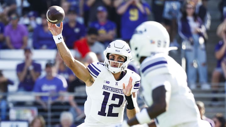 Sep 21, 2024; Seattle, Washington, USA; Northwestern Wildcats quarterback Jack Lausch (12) passes against the Washington Huskies during the first quarter at Alaska Airlines Field at Husky Stadium. Mandatory Credit: Joe Nicholson-Imagn Images