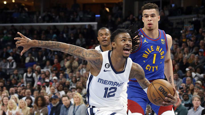 Memphis Grizzlies guard Ja Morant (12) drives to the basket as Denver Nuggets forward Michael Porter Jr. (1) defends during the second half at FedExForum. Mandatory Credit: Petre Thomas-Imagn Images