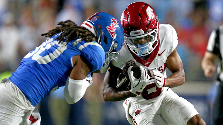 Arkansas receiver Raylen Sharpe (6) runs after a catch as Ole Miss linebacker Jaden Yates (30) makes the tackle during the fourth quarter at Vaught-Hemingway Stadium. 
