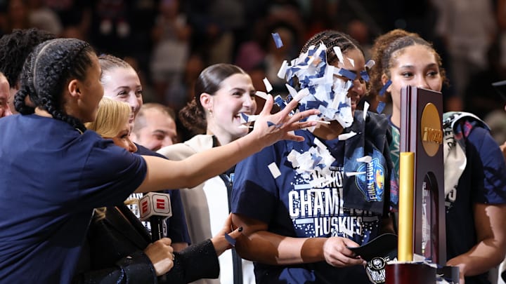 Apr 6, 2025; Tampa, FL, USA; Connecticut Huskies guard Azzi Fudd (35) throws confetti at teammate forward Sarah Strong (21) after the national championship of the women's 2025 NCAA tournament against the South Carolina Gamecocks at Amalie Arena. Mandatory Credit: Nathan Ray Seebeck-Imagn Images