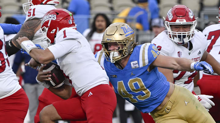 Nov 30, 2024; Pasadena, California, USA; UCLA Bruins linebacker Carson Schwesinger (49) sacks Fresno State Bulldogs quarterback Mikey Keene (1) during the second quarter at Rose Bowl. Mandatory Credit: Robert Hanashiro-Imagn Images