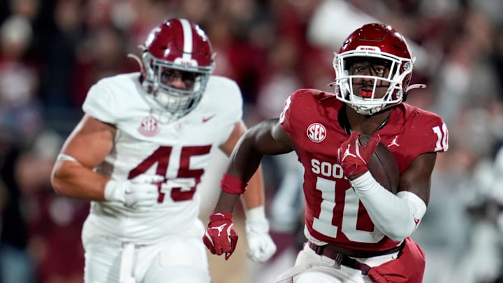 Oklahoma Sooners linebacker Kip Lewis (10) retuns an interception for a touchdown in front of Alabama Crimson Tide tight end Robbie Ouzts (45) during a college football game between the University of Oklahoma Sooners (OU) and the Alabama Crimson Tide at Gaylord Family - Oklahoma Memorial Stadium in Norman, Okla., Saturday, Nov. 23, 2024. Oklahoma won 24-3.