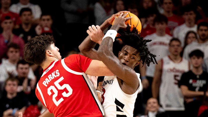 Ohio State Buckeyes center Austin Parks (25) fouls Cincinnati Bearcats guard-forward Rayvon Griffith (3) in the first half of a basketball scrimmage between Cincinnati Bearcats and Ohio State Buckeyes at Fifth Third Arena in Cincinnati on Friday, Oct. 18, 2024.