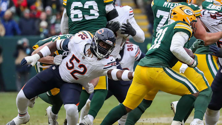 Chicago Bears defensive end Darrell Taylor (52) reaches for Green Bay Packers running back Emanuel Wilson (31) on Sunday, January 5, 2025, at Lambeau Field in Green Bay, Wis. 
Tork Mason/USA TODAY NETWORK-Wisconsin