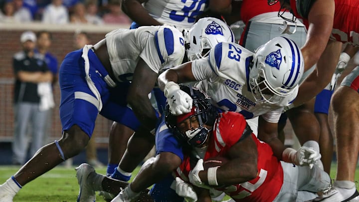 Aug 30, 2025; Oxford, Mississippi, USA; Mississippi Rebels running back Logan Diggs (22) dives into the end zone for a touchdown as Georgia State Panthers defensive back Jaylen Jones (23) attempts to make the stop during the fourth quarter at Vaught-Hemingway Stadium. Mandatory Credit: Petre Thomas-Imagn Images