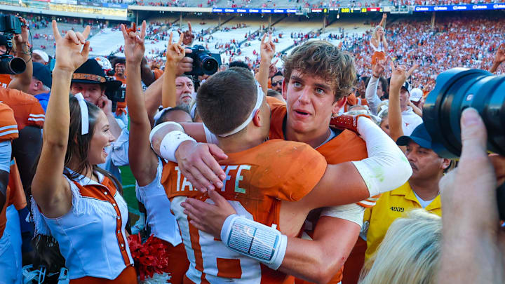 Texas Longhorns quarterback Arch Manning (16) hugs Texas Longhorns defensive back Michael Taaffe (16) after the game against the Oklahoma Sooners at the Cotton Bowl.