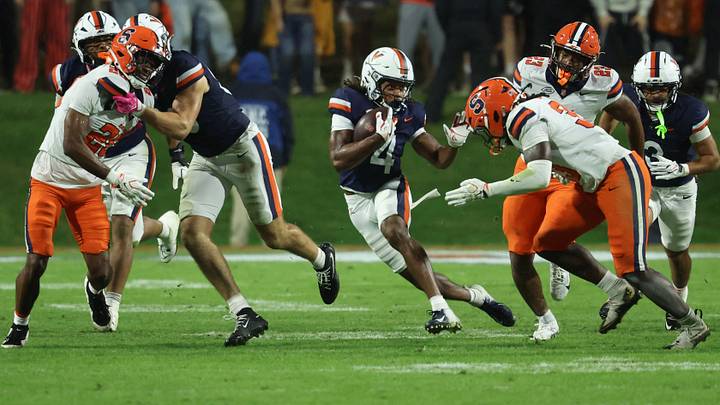 Oct 10, 2026; Charlottesville, Virginia, USA; Virginia Cavaliers wide receiver Jacquon Gibson (4) returns a kickoff as Syracuse Orange linebacker Gemaus Sackie (33) chases in the fourth quarter at Scott Stadium. Mandatory Credit: Geoff Burke-Imagn Images