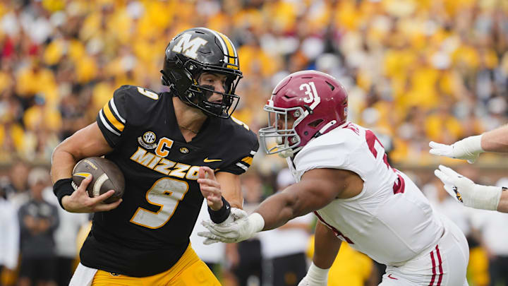 Oct 11, 2025; Columbia, Missouri, USA; Missouri Tigers quarterback Beau Pribula (9) runs the ball against Alabama Crimson Tide defensive lineman Keon Keeley (31) during the second half of the game at Faurot Field at Memorial Stadium. Mandatory Credit: Jay Biggerstaff-Imagn Images