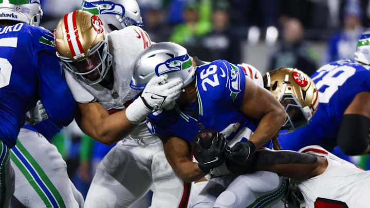 San Francisco 49ers defensive end Nick Bosa (97) assists on a tackle of Seattle Seahawks running back Zach Charbonnet (26) San Francisco 49ers defensive end Nick Bosa (97) assists on a tackle of Seattle Seahawks running back Zach Charbonnet (26)