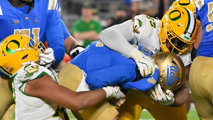 Sep 28, 2024; Pasadena, California, USA; Oregon Ducks defensive end Matayo Uiagalelei (10) and defensive lineman Derrick Harmon (55) sacks CLA Bruins quarterback Ethan Garbers (4) at Rose Bowl. Mandatory Credit: Robert Hanashiro-Imagn Images