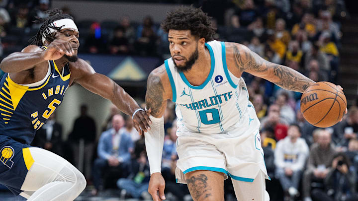 Nov 19, 2025; Indianapolis, Indiana, USA; Charlotte Hornets forward Miles Bridges (0) dribbles the ball while Indiana Pacers forward Jarace Walker (5) defends in the first half at Gainbridge Fieldhouse. Mandatory Credit: Trevor Ruszkowski-Imagn Images