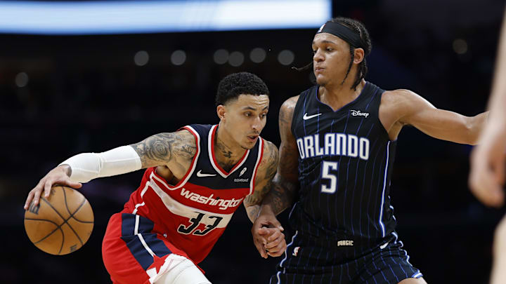 Mar 6, 2024; Washington, District of Columbia, USA; Washington Wizards forward Kyle Kuzma (33) drives to the basket as Orlando Magic forward Paolo Banchero (5) defends in the second half at Capital One Arena. Mandatory Credit: Geoff Burke-Imagn Images