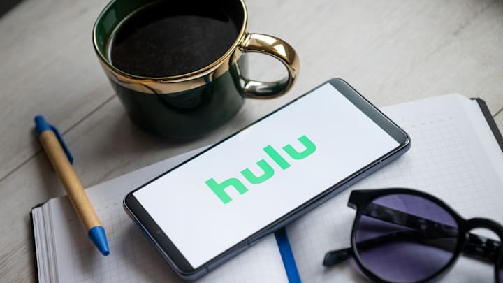 In this photo illustration a Hulu logo seen displayed on a...