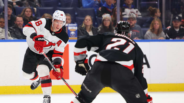 Nov 28, 2025; Buffalo, New York, USA;  Buffalo Sabres defenseman Conor Timmins (21) looks to block a pass b y New Jersey Devils left wing Ondrej Palat (18) during the third period at KeyBank Center. Mandatory Credit: Timothy T. Ludwig-Imagn Images