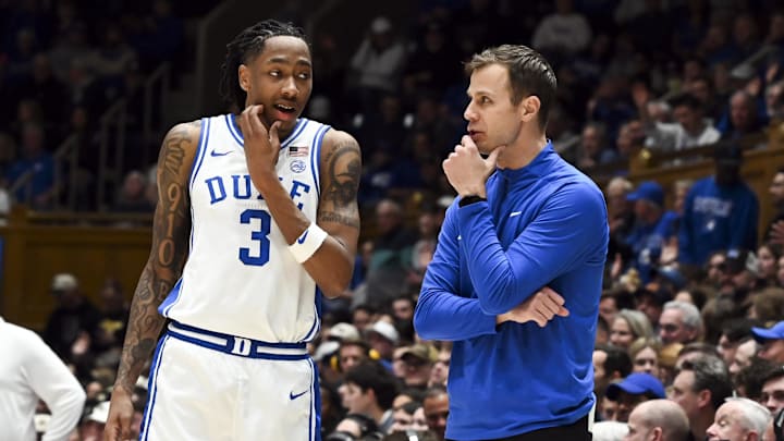 Jan 24, 2026; Durham, North Carolina, USA; Duke Blue Devils head coach Jon Scheyer (right) talks to forward Isaiah Evans (3) during the second half against the Wake Forest Demon Deacons at Cameron Indoor Stadium. Mandatory Credit: Rob Kinnan-Imagn Images