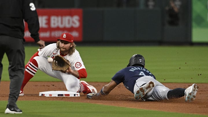 Sep 6, 2024; St. Louis, Missouri, USA; Seattle Mariners center fielder Julio Rodriguez (44) safely steals second base ahead of the tag from St. Louis Cardinals second baseman Brendan Donovan (33) in the first inning at Busch Stadium. Mandatory Credit: Joe Puetz-Imagn Images