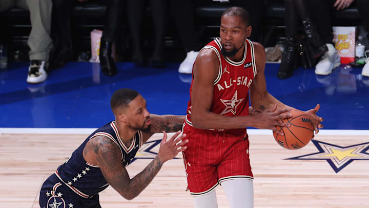 Feb 18, 2024; Indianapolis, Indiana, USA; Western Conference forward Kevin Durant (35) of the Phoenix Suns looks to pass the ball against Eastern Conference guard Damian Lillard (0) of the Milwaukee Bucks during the second quarter in the 73rd NBA All Star game at Gainbridge Fieldhouse. Mandatory Credit: Trevor Ruszkowski-Imagn Images