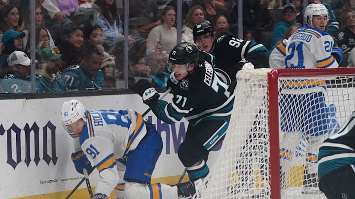 Mar 30, 2026; San Jose, California, USA;  San Jose Sharks center Macklin Celebrini (71) and left wing Igor Chernyshov (92) challenge St. Louis Blues left winger Dylan Holloway (81) and right winger Jimmy Snuggerud (21) for the puck in the first period at SAP Center at San Jose. Mandatory Credit: David Gonzales-Imagn Images