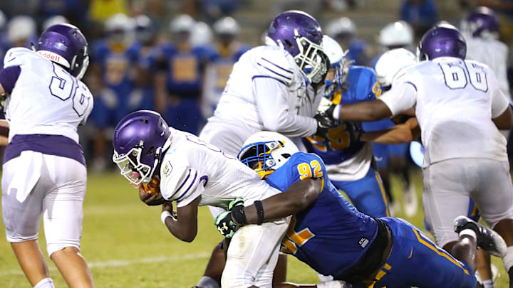 Gainesville High School Joh Cooper (9) is tackled by Newberry High School's Jarquez Carter (92) as he runs the ball, during a spring football game at NHS in Newberry FL. May 20, 2022. [Brad McClenny/The Gainesville Sun]

Flgai 052022 Ghsvnewberryspringfb 09