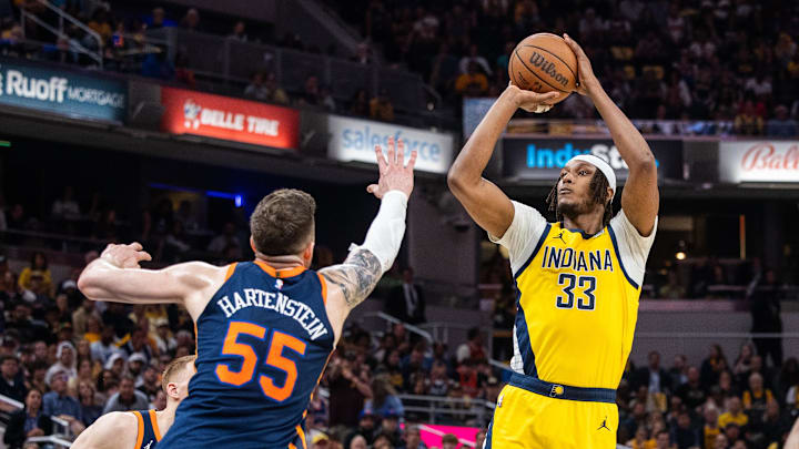 May 12, 2024; Indianapolis, Indiana, USA; Indiana Pacers center Myles Turner (33) shoots the ball while New York Knicks center Isaiah Hartenstein (55) defends during game four of the second round for the 2024 NBA playoffs at Gainbridge Fieldhouse. Mandatory Credit: Trevor Ruszkowski-USA TODAY Sports