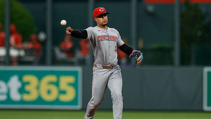 Apr 25, 2025; Denver, Colorado, USA; Cincinnati Reds second baseman Santiago Espinal (4) throws to first for an out in the first inning against the Colorado Rockies at Coors Field. Mandatory Credit: Isaiah J. Downing-Imagn Images