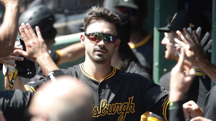 Aug 28, 2024; Pittsburgh, Pennsylvania, USA;  Pittsburgh Pirates left fielder Bryan Reynolds (10) celebrates his solo home run in the dugout against the Chicago Cubs during the first inning at PNC Park. Mandatory Credit: Charles LeClaire-Imagn Images