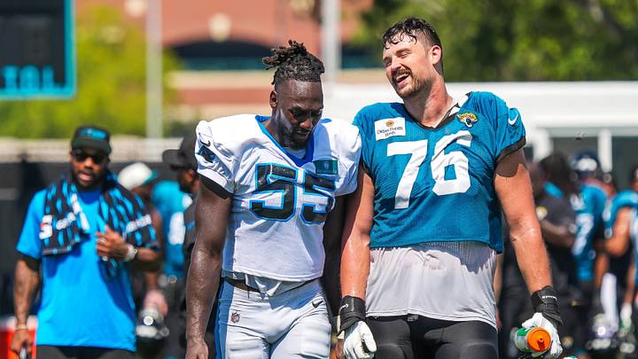 Carolina Panthers linebacker Devin Lloyd (55) has a laugh with Jacksonville Jaguars guard Ezra Cleveland (76) after a joint practice Carolina Panthers linebacker Devin Lloyd (55) has a laugh with Jacksonville Jaguars guard Ezra Cleveland (76) after a joint practice