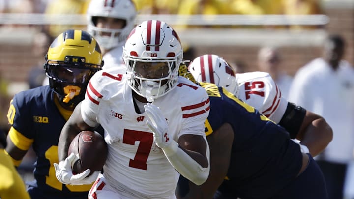 Oct 4, 2025; Ann Arbor, Michigan, USA;  Wisconsin Badgers running back Dilin Jones (7) rushes in the first half against the Michigan Wolverines at Michigan Stadium. Mandatory Credit: Rick Osentoski-Imagn Images