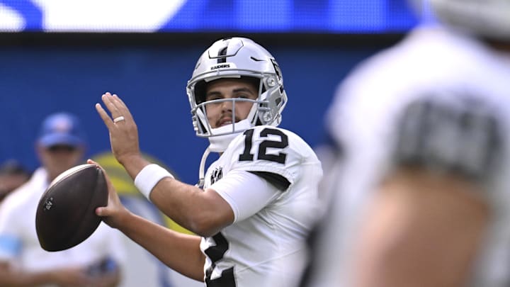 Oct 20, 2024; Inglewood, California, USA; Las Vegas Raiders quarterback Aidan O'Connell (12) throws a pass during warmups before the game against the Los Angeles Rams at SoFi Stadium. Mandatory Credit: Alex Gallardo-Imagn Images