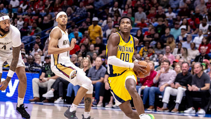 Nov 1, 2024; New Orleans, Louisiana, USA;  Indiana Pacers guard Bennedict Mathurin (00) drives to the basket against New Orleans Pelicans forward Brandon Ingram (14) during the second half at Smoothie King Center. Mandatory Credit: Stephen Lew-Imagn Images