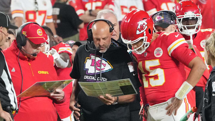 Oct 7, 2024; Kansas City, Missouri, USA; Kansas City Chiefs quarterback Patrick Mahomes (15) looks at plays with offensive coordinator Matt Nagy, center, and head coach Andy Reid against the New Orleans Saints during the first half at GEHA Field at Arrowhead Stadium. Mandatory Credit: Denny Medley-Imagn Images
