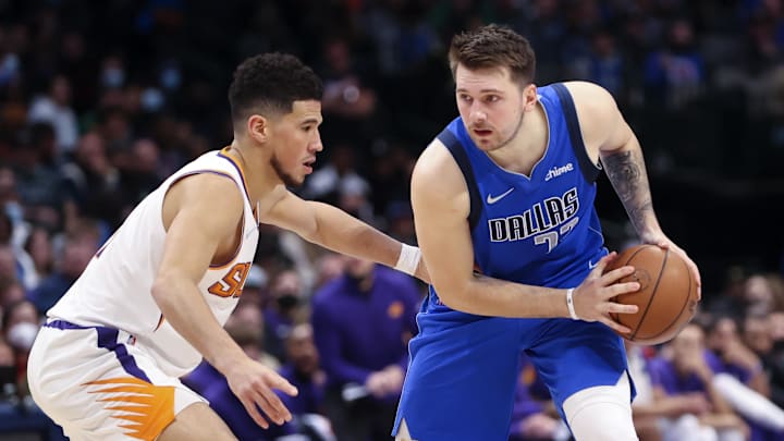Jan 20, 2022; Dallas, Texas, USA; Dallas Mavericks guard Luka Doncic (77) looks to score as Phoenix Suns guard Devin Booker (1) defends during the second half at American Airlines Center. Mandatory Credit: Kevin Jairaj-Imagn Images