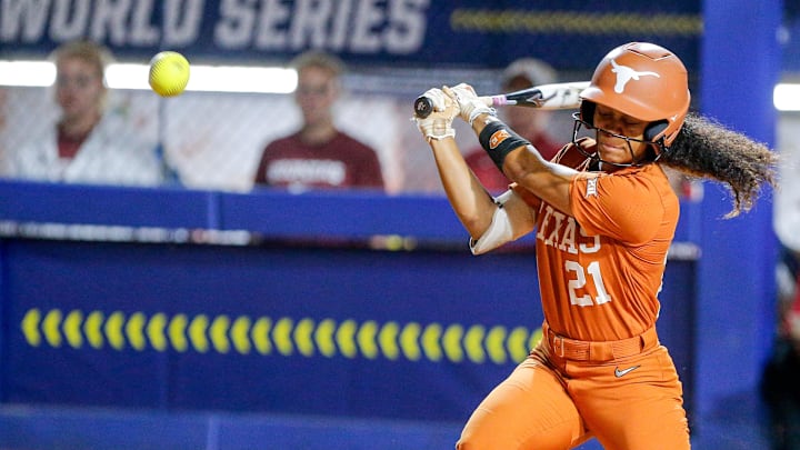 Texas outfielder Kayden Henry (21) gets a base hit in the fifth inning of the first game of the Women’s College World Series softball championship series between the Oklahoma Sooners and the Texas Longhorns at Devon Park in Oklahoma City on Wednesday, June 5, 2024.