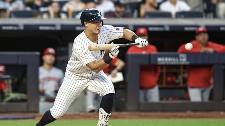 Jul 3, 2024; Bronx, New York, USA; New York Yankees shortstop Anthony Volpe (11) attempts to bunt for a base hit in the fifth inning against the Cincinnati Reds at Yankee Stadium. Mandatory Credit: Wendell Cruz-USA TODAY Sports