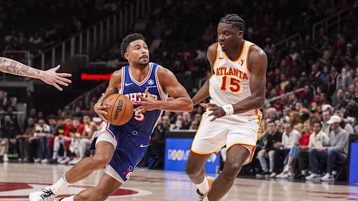 Mar 10, 2025; Atlanta, Georgia, USA; Philadelphia 76ers guard Quentin Grimes (5) drives to the basket against Atlanta Hawks center Clint Capela (15) during the first half at State Farm Arena. Mandatory Credit: Dale Zanine-Imagn Images