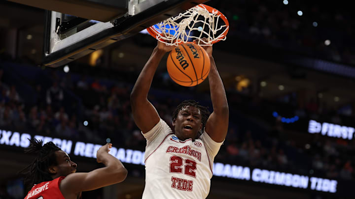 Mar 22, 2026; Tampa, FL, USA; Alabama Crimson Tide forward Aiden Sherrell (22) dunks past Texas Tech Red Raiders forward Luke Bamgboye (9) in the first half during a second round game of the men's 2026 NCAA Tournament at Benchmark International Arena. 