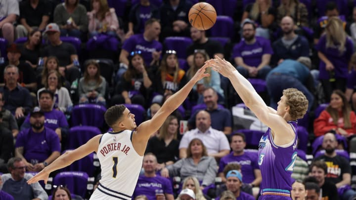 Oct 19, 2022; Salt Lake City, Utah, USA;  Utah Jazz forward Lauri Markkanen (23) shoots the ball over Denver Nuggets forward Michael Porter Jr. (1) during the first quarter at Vivint Arena. Mandatory Credit: Chris Nicoll-USA TODAY Sports