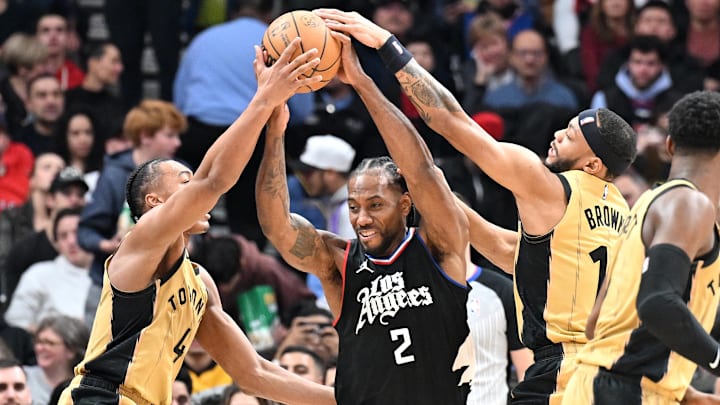 Jan 26, 2024; Toronto, Ontario, CAN;   Los Angeles Clippers forward Kawhi Leonard (2) battles for the ball against Toronto Raptors forward Scottie Barnes (4) and guard Bruce Brown (11) in the first half at Scotiabank Arena. Mandatory Credit: Dan Hamilton-Imagn Images