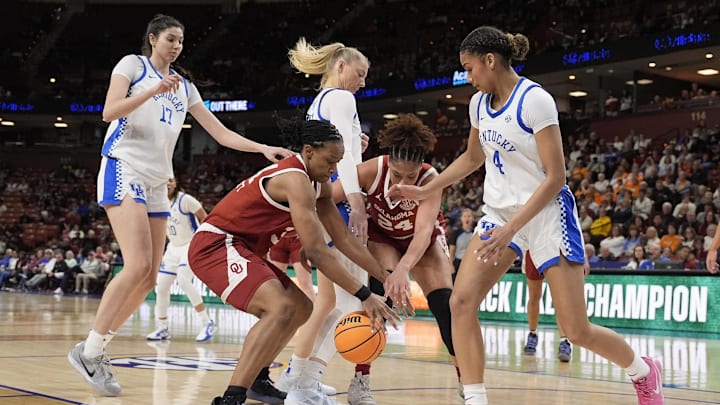 Mar 7, 2025; Greenville, SC, USA; Oklahoma Sooners guard Zya Vann (3) and forward Skylar Vann (24) scramble for the loose ball against Kentucky Wildcats guard Lexi Blue (4) and center Clara Strack (13) during the first half at Bon Secours Wellness Arena. Mandatory Credit: Jim Dedmon-Imagn Images